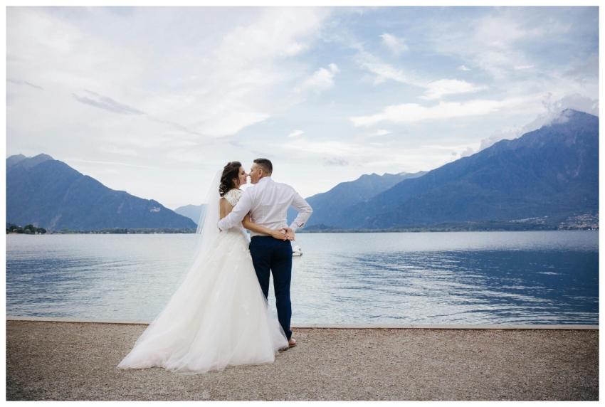 Bride and groom share a romantic moment by Lake Co