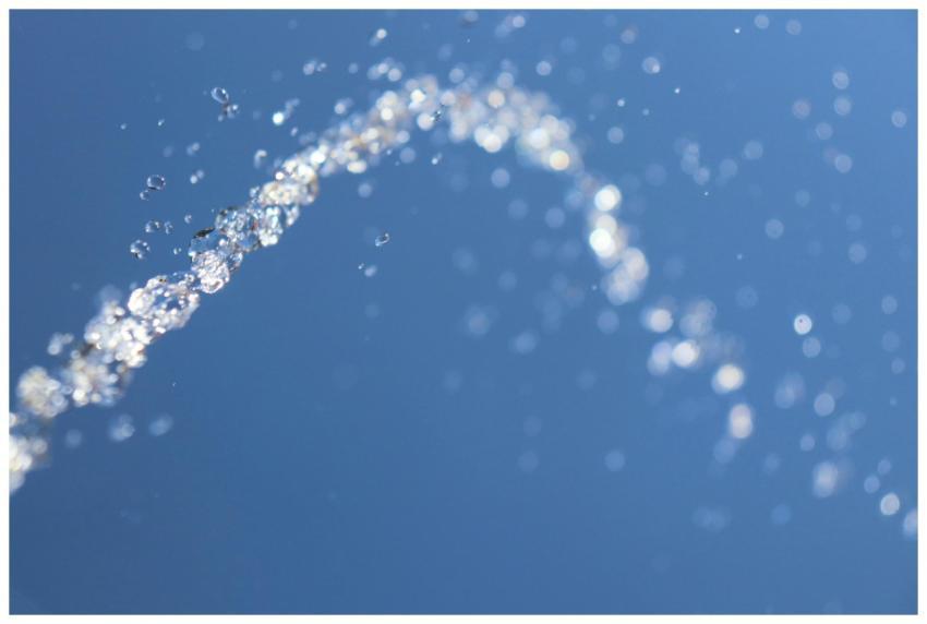 Macro shot of water droplets suspended in mid-air