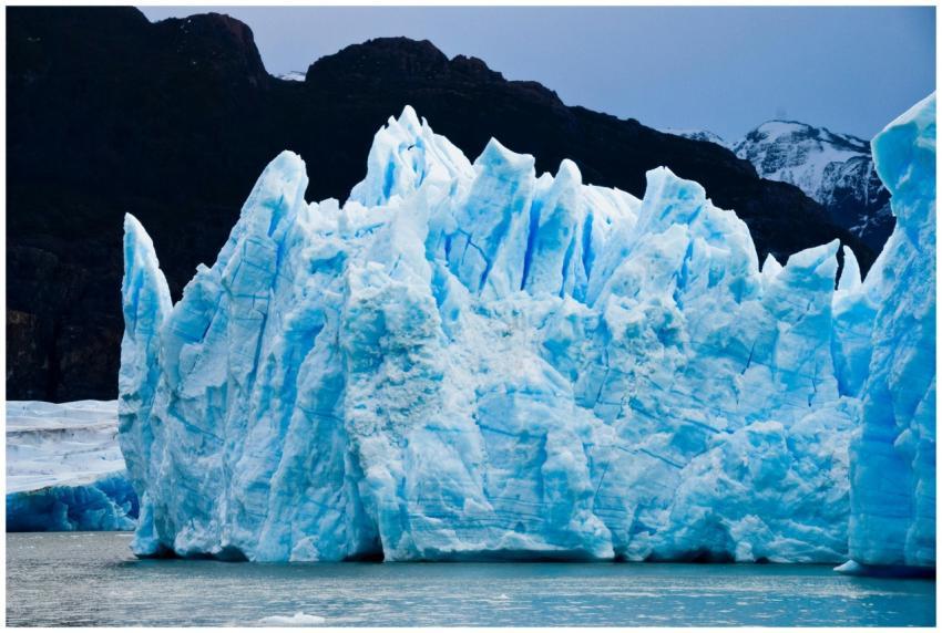 A stunning view of a towering blue glacier in the