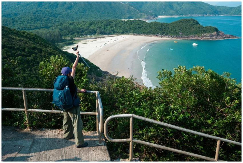 A hiker with a backpack photographs a breathtaking