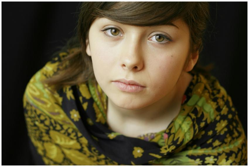 Close-up portrait of a young girl with an intricat