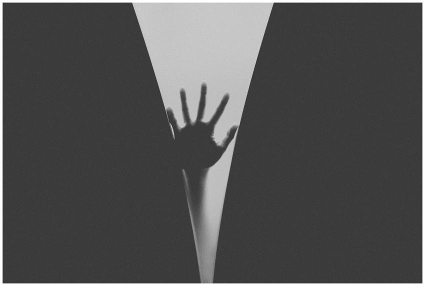 Artistic black and white silhouette of a hand pres