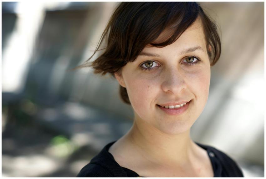 Smiling young woman with short brunette hair posin
