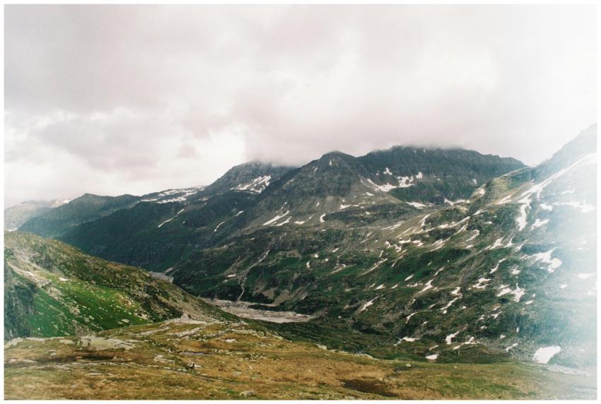 Dramatic view of the snow-capped mountains with lu