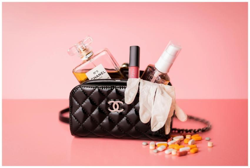 Chanel bag featuring perfume, gloves, and medicine