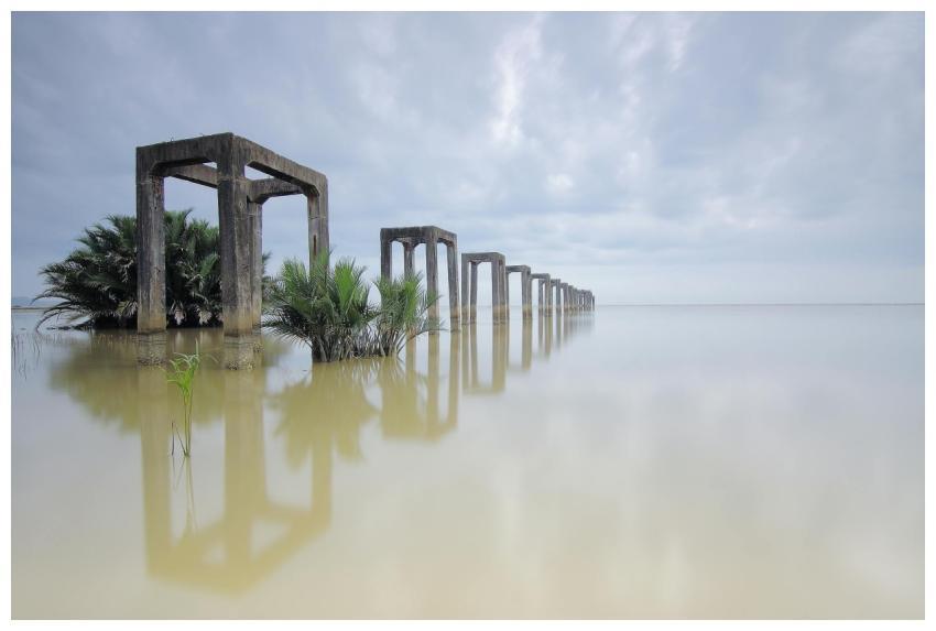 Tranquil scene featuring pillars submerged in wate