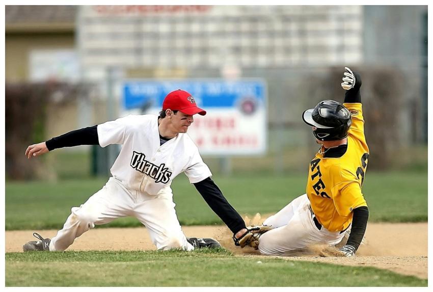 Two baseball players in action during a competitiv