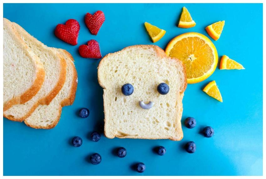Fun and colorful toast face art with blueberries,