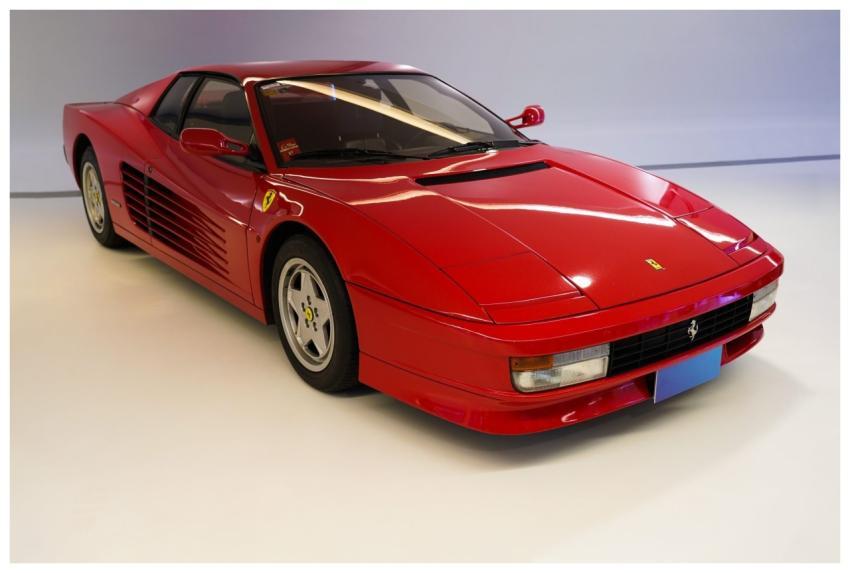 A red sports car with a sleek design and prominent