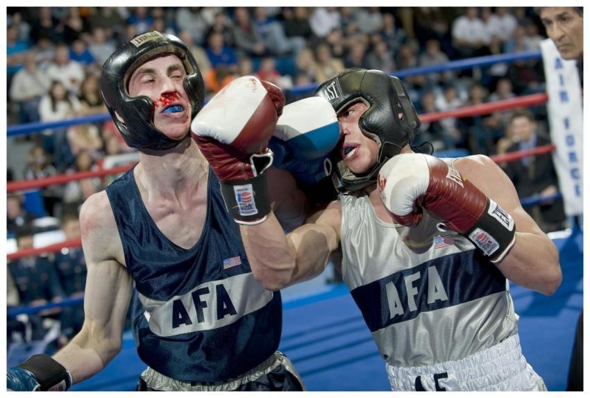 Two boxers in a heated match deliver powerful punc