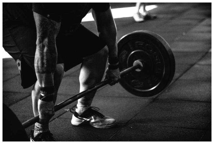 A powerful black and white image of a man deadlift