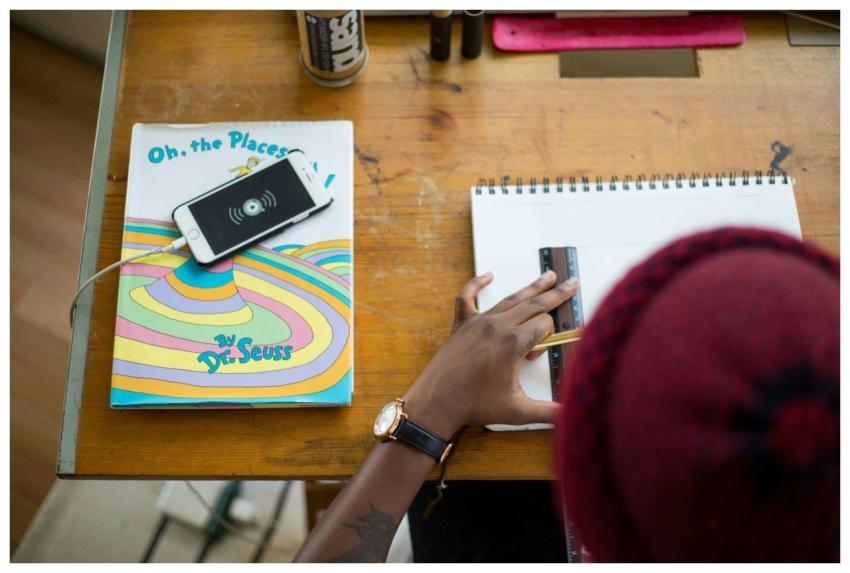 Workspace with drawing, smartphone, and Dr. Seuss