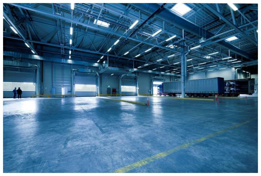 Wide view of an empty modern warehouse with indust