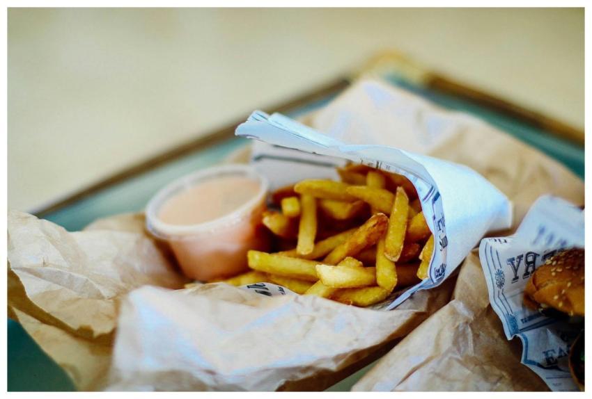 Delicious serving of crispy fries, burger, and dip