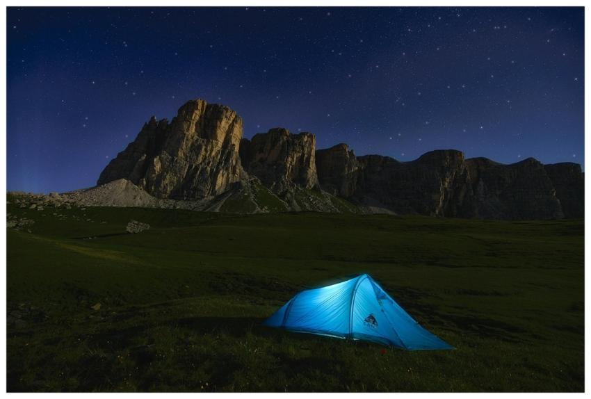 Camping under the starlit sky in the Dolomites, wi