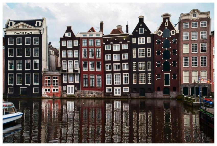 Picturesque row of Amsterdam houses by the canal r