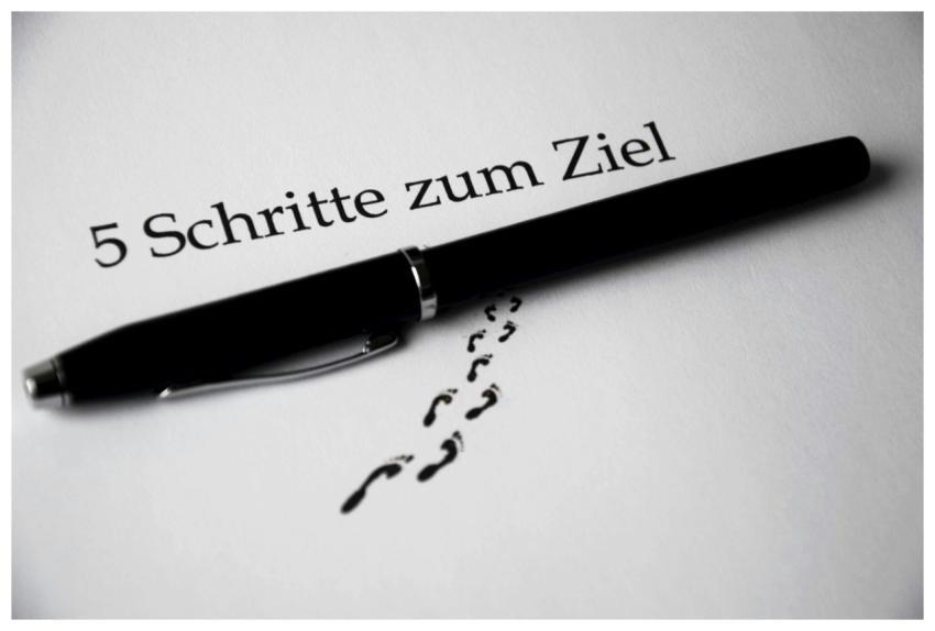 A black pen on a paper with text and footprint vis