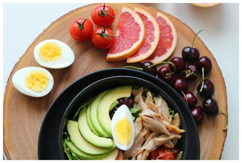 A vibrant, healthy salad bowl with avocado, eggs,