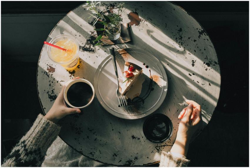 Overhead view of a cozy café table with a slice of