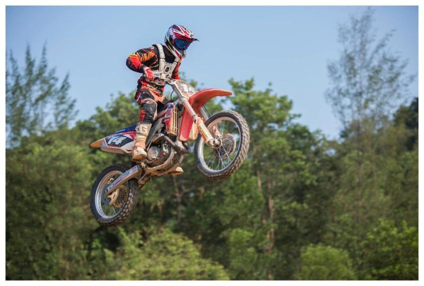 A motocross rider performs an aerial stunt in a vi