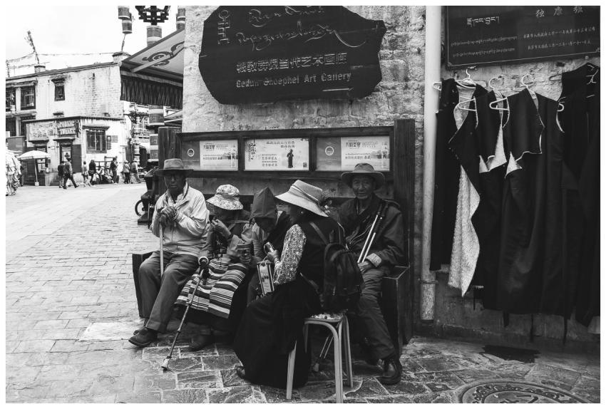 Monochrome photo capturing seniors sitting outdoor