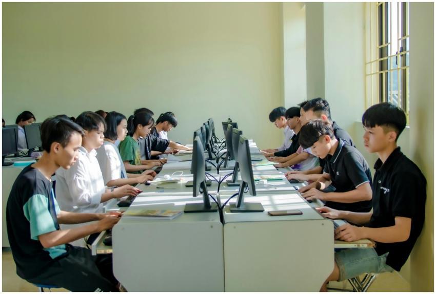 A group of students in a classroom focused on comp