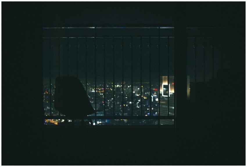 Silhouette of a chair on a balcony overlooking the