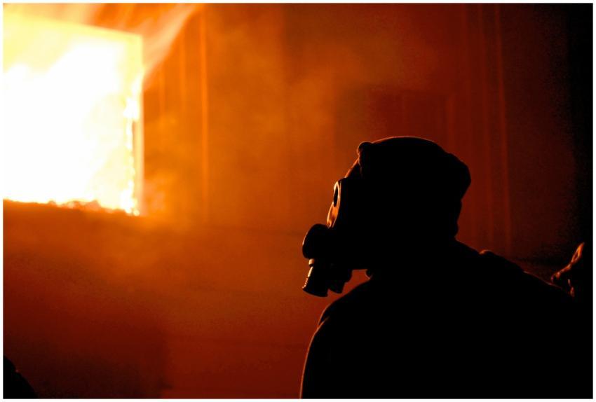 Eerie silhouette of a person with a gas mask in pr