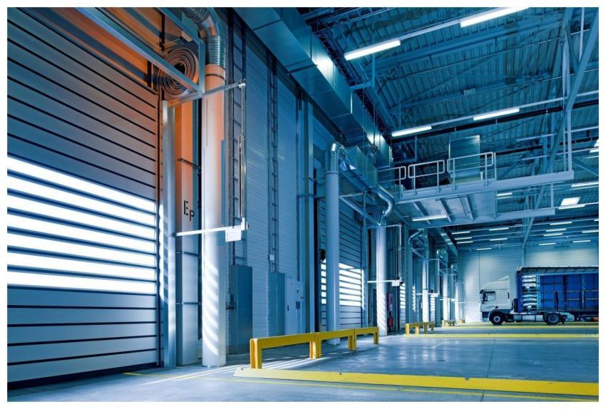 Spacious and modern warehouse interior with parked