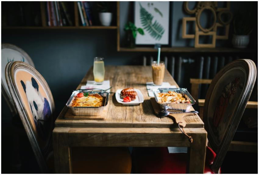 A rustic dining setup with served meals and bevera