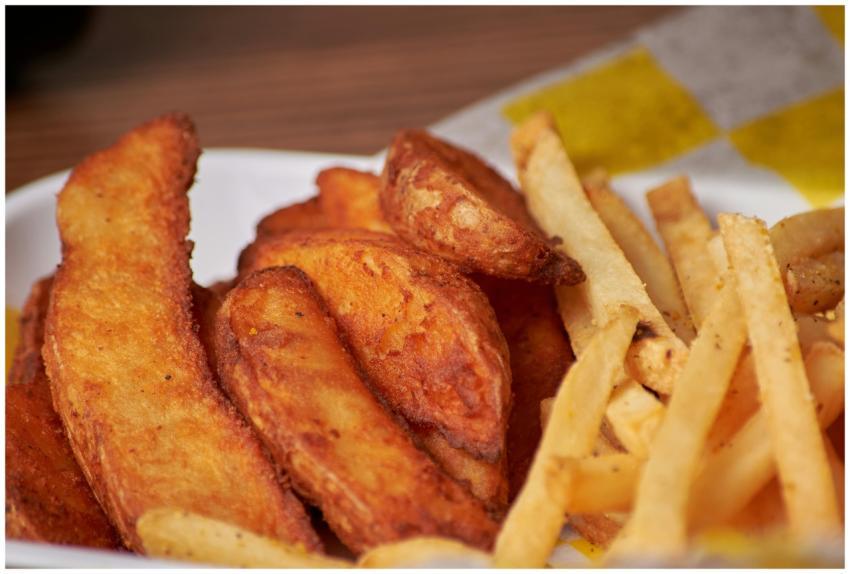 Appetizing close-up of crispy French fries and pot