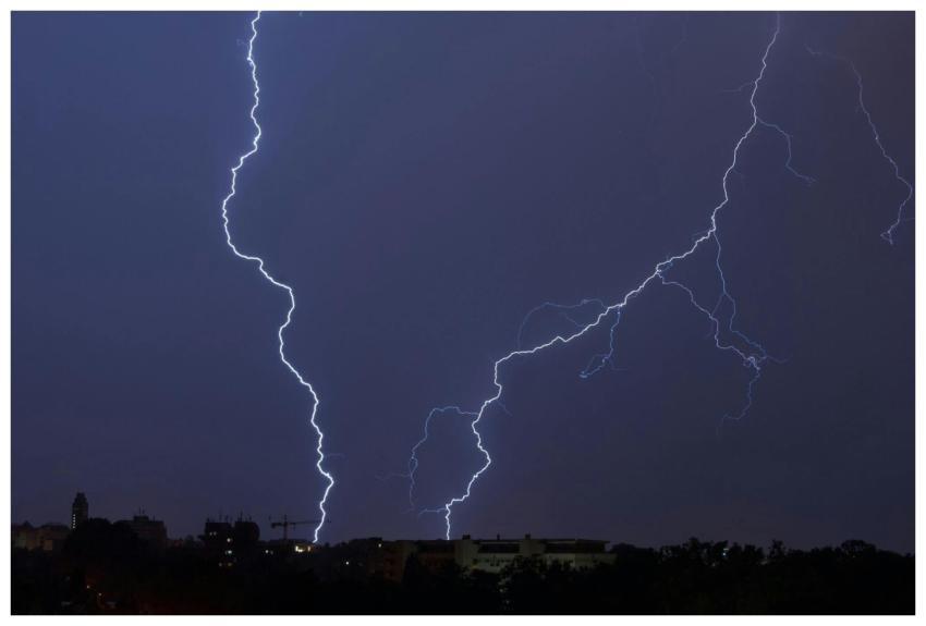 Dramatic lightning bolt illuminating the night sky