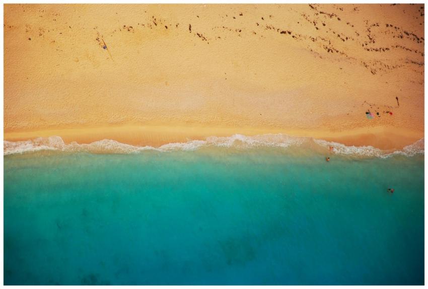 A stunning aerial shot of a sandy beach meeting tu