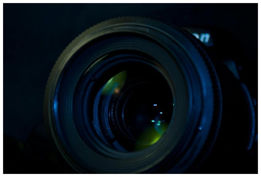 Detailed close-up of a camera lens reflecting ligh