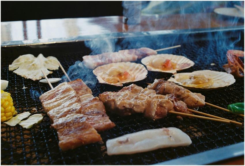 Grilled Japanese skewers and seafood sizzling on a