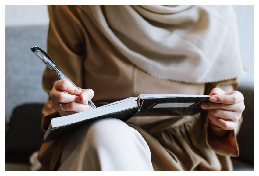 Muslim Woman Writing Notebook
