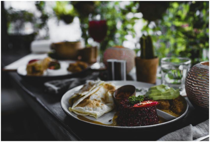 Plate with delicious red rice served with roti bre