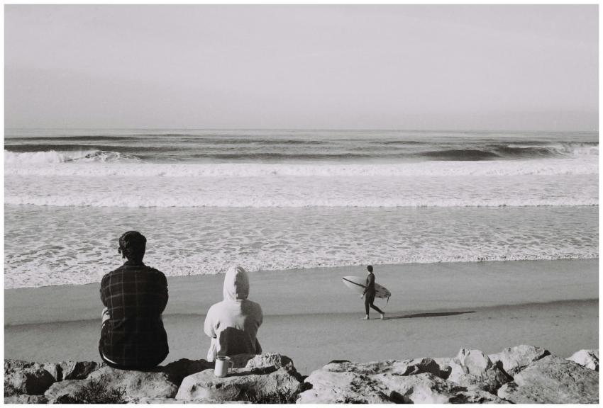 Monochrome photo of surf watching on a tranquil be