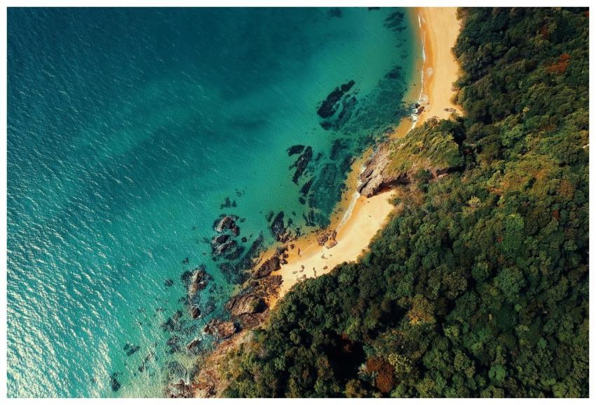 Stunning aerial view of a turquoise sea meeting a