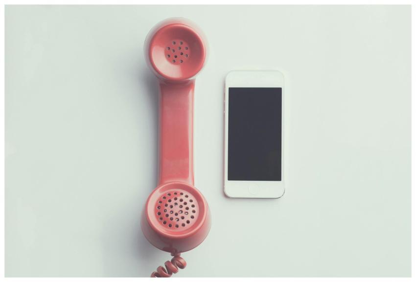 Comparison of a vintage pink telephone receiver an