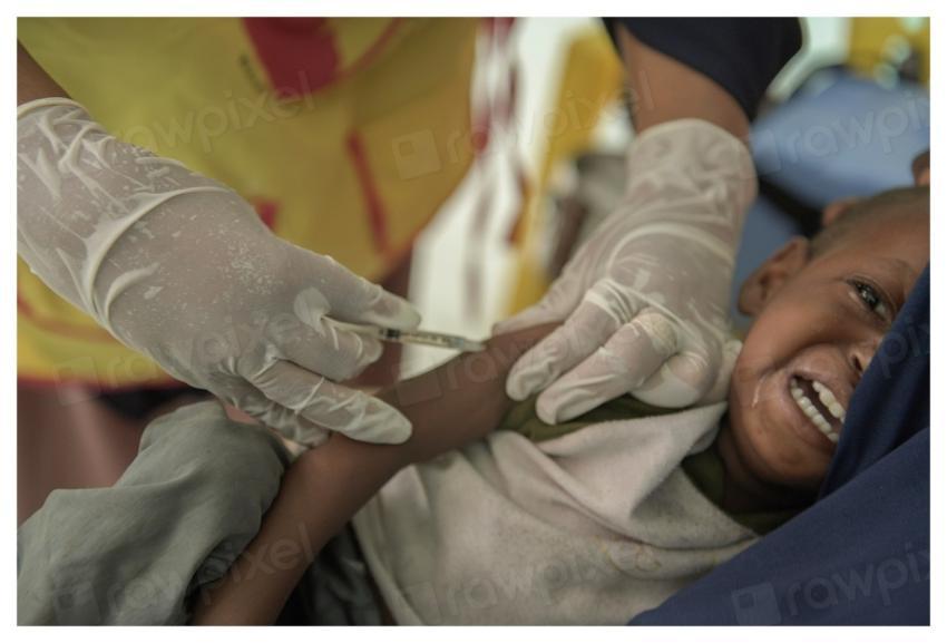A health worker vaccinates a child