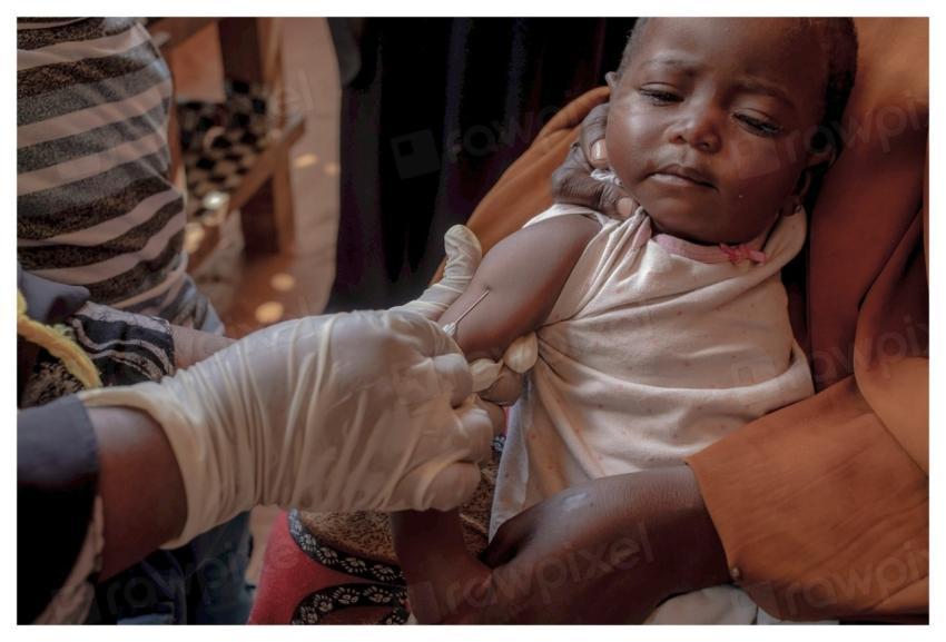 A health worker injects a vaccine
