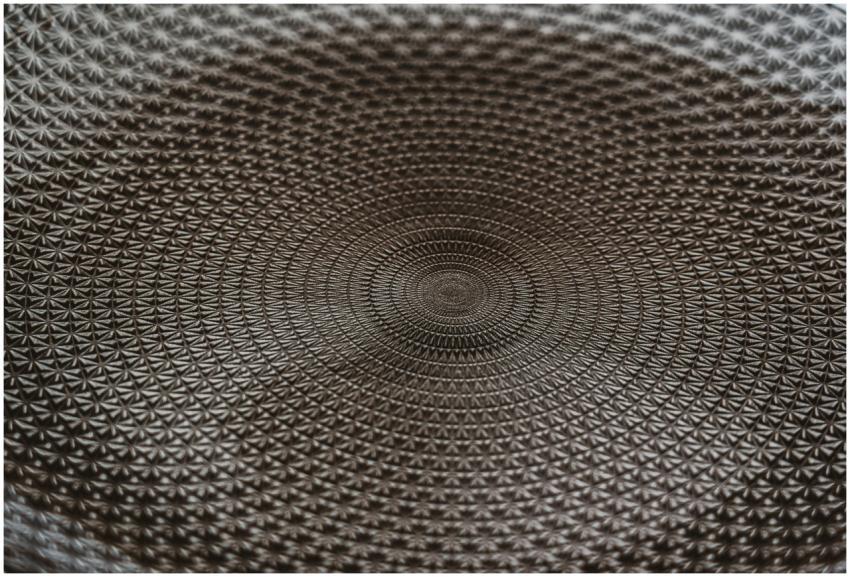 Detailed close-up of a metallic geometric pattern,