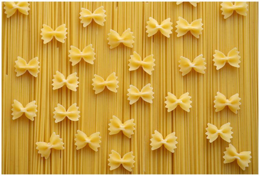 Flat lay of Italian pasta varieties, showcasing fa