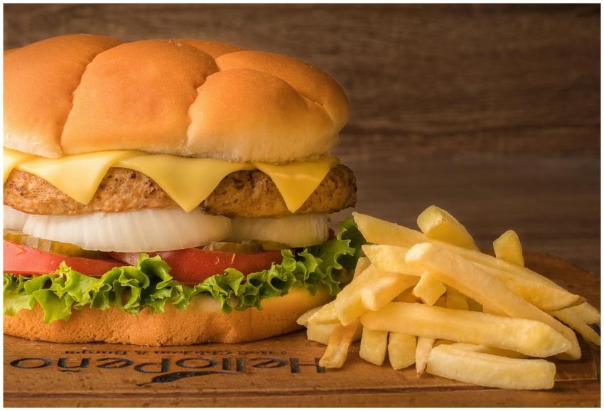 Close-up of a cheeseburger with lettuce, tomato, o