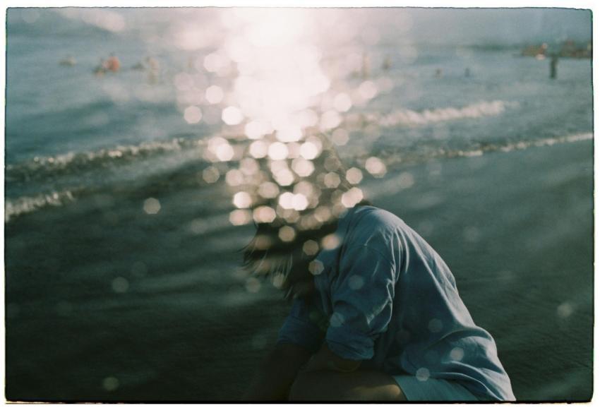 A serene beach scene with sunlight reflecting on w
