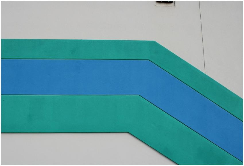 Abstract geometric design in teal and blue on a wa