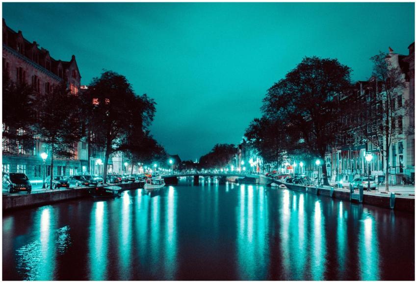 A vibrant night scene of Amsterdam's iconic canals
