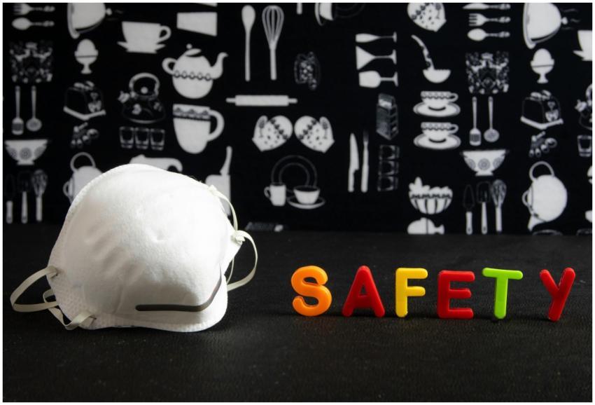 Face mask next to colorful 'SAFETY' letters agains