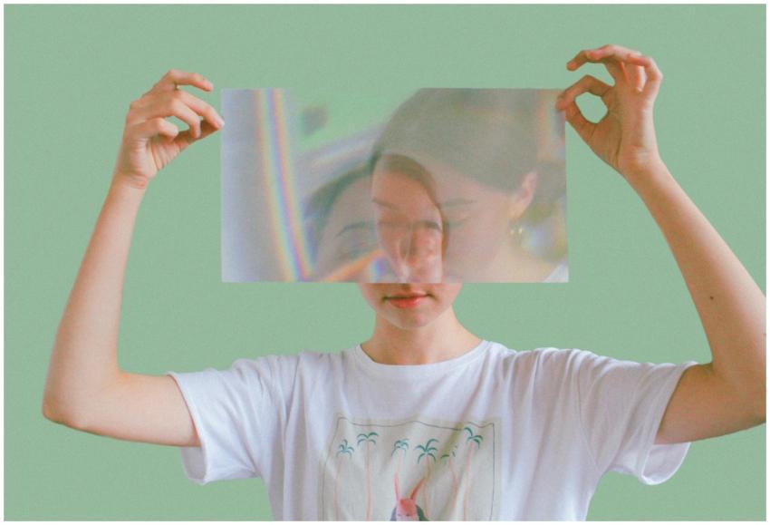 Artistic portrait of a woman holding a reflective